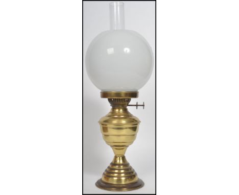 A vintage 20th century duplex brass oil lamp by S.Heath and Sons having a banded tapering base with bulbous font, twin pusher