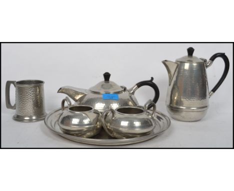 A retro Tudoric style pewter made tea service by Hall Brothers, including the tray, teapot etc. Makers marks to base.21 cm hi
