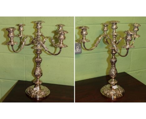 A pair of silver-plated five-light candelabra, 19th century, each on circular base, stamped with foliage and rocaille, the de
