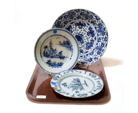 An English Delft plate, circa 1750, painted in blue with a chinoiserie figure in a fenced garden within a foliate border, 23.