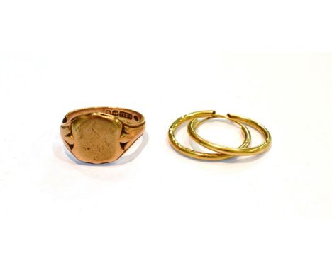 A 9 carat gold signet ring, band cut; and a pair of 9 carat gold hoop earrings.  Gross weight 8.3 grams. 