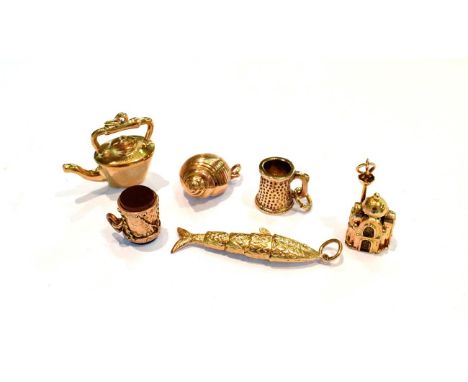 Three 9 carat gold charms including an articulated fish, a tankard and a kettle; a hardstone set drum charm stamped '9CT'; an