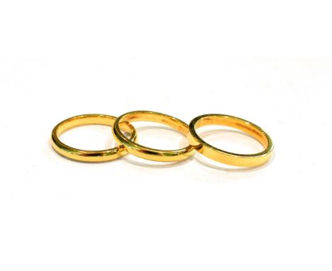 Three 18 carat gold band rings, finger sizes H1/2, I and I1/2 (3) .  Two with marks slightly rubbed. Gross weight 6.6 grams. 