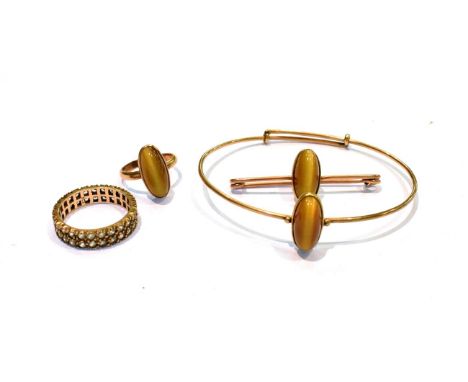 A two row gem set eternity ring, stamped '9CT', finger size Q1/2; and a suite of jewellery comprising a bangle, a brooch and 