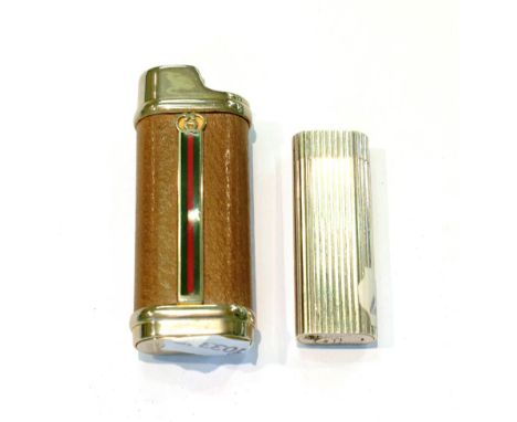 A Cartier roller cigarette lighter No. N74286, together with a Gucci cigarette lighter (2)