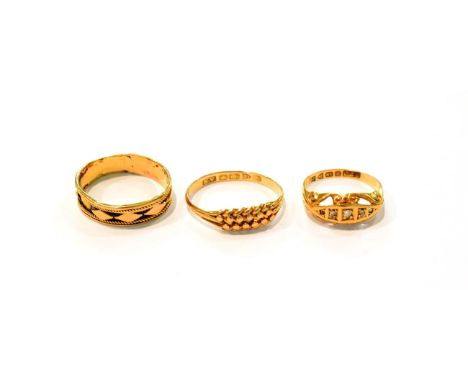 An 18 carat gold fancy band ring and another 18 carat gold ring, both out of shape; together with five stone gem set ring (on