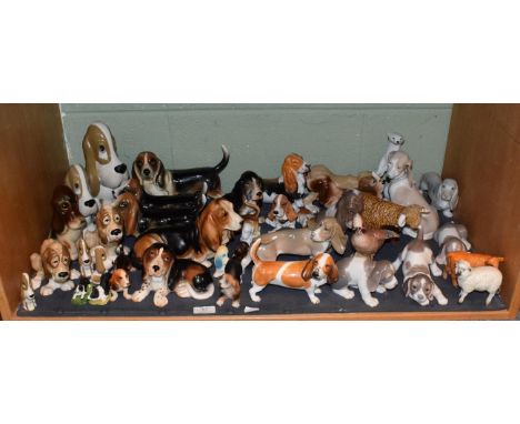 A collection of ceramic animals, mostly Bassett hounds, to include Beswick Jay no. 2417, a sheep and a calf; together with fo