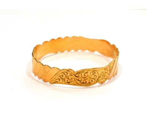 An Eastern yellow metal bangle, stamped '22CT'.  Gross weight 26.5 grams. 