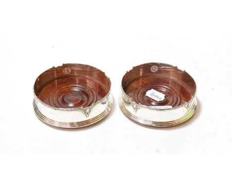 A pair of Elizabeth II silver coasters, by K M Silver, Birmingham, 1998, cylindrical the shaped rim with ovolo cast border, w