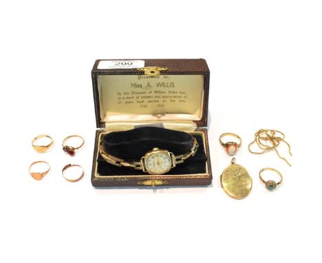 A 9 carat gold watch; a 9 carat gold locket; a 9 carat gold signet ring, finger size L1/2; three further 9 carat gold rings i