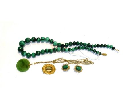 A citrine brooch, unmarked, measures 3.2cm by 2.5cm; a single row malachite bead necklace with 9 carat gold snap, length 46cm