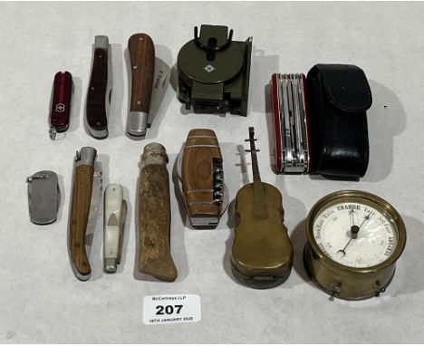 Nine folding pocket knives; a brass barometer; a military style compass and a novelty inkwell.