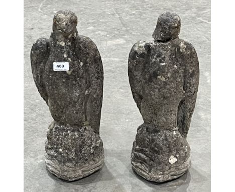 A pair of bird of prey garden ornaments. 17" high. One with detached head