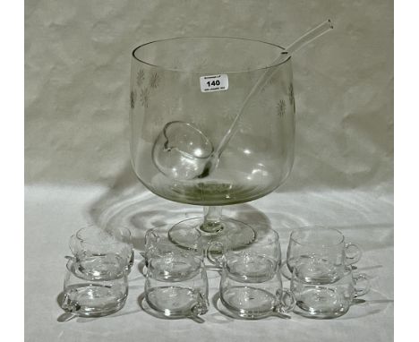 A wheel engraved glass punchbowl with ladle and eight cups. The bowl 11½" high.