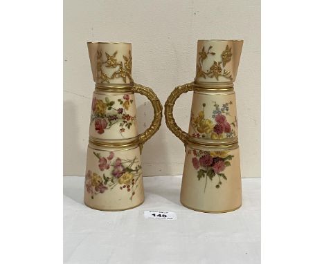 A pair of Royal Worcester blush ivory conical ewers, shape 1047, gilded and painted with summer flowers. Date code 1913. 8" h