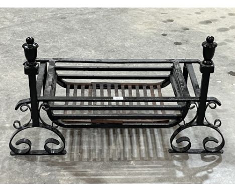 A cast iron fire grate and fire dogs. 29" wide
