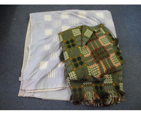 Two vintage green ground Welsh tapestry blankets with fringed edges. Together with a blue ground patchwork quilt with Laura A