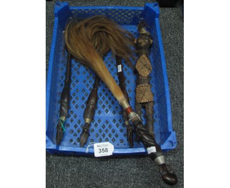 Box containing souvenir tribal items to include; carved figure, fork, spoon and knife set and fly swisher. (B.P. 24% incl. VA