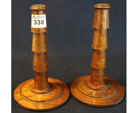 Pair of oak Art Deco design candle sticks on circular step bases. (B.P. 24% incl. VAT)