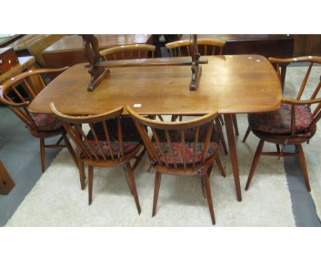 Elm rectangular Ercol dining table on square tapering legs, together with a set of six matching spindle Ercol chairs, two arm