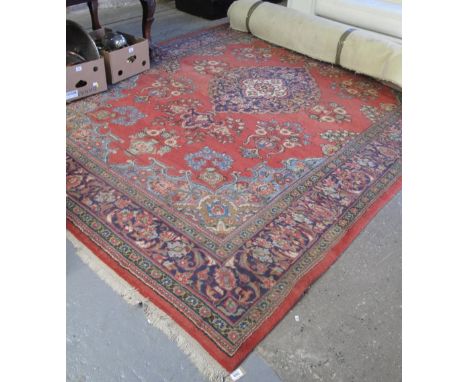 20th Century Persian design red ground foliate carpet. 360 x 259cm approx. (B.P. 24% incl. VAT)
