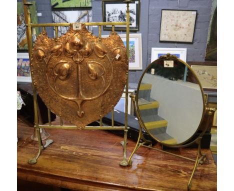 Art Deco design repousse brass fire screen with foliate decoration, together with a brass framed toilet mirror. (2)(B.P. 24% 