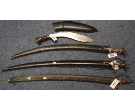 Two Indian ceremonial Tulwar swords with leather scabbards, together with a Nepalese Kukri with scabbard. (3) (B.P. 24% incl.