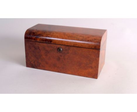 An early 19th century burr walnut tea caddy, the domed edged rectangular hinged lid, opening to central glass mixing bowl, fl