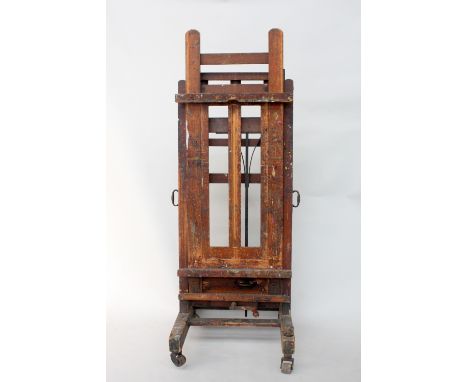 A large oak Windsor and Newton artist`s fully adjustable studio easel 216cm high x76cm wide. 