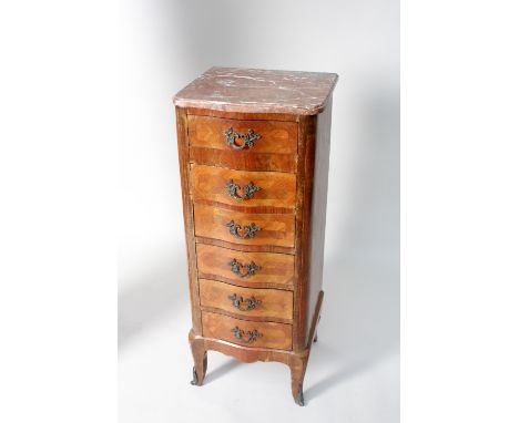 A Louis XVI style kingwood petit commode, the marble top over serpentine front of six layered drawers, over cabriole legs wit