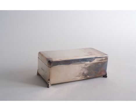 An Art Deco silver cigarette box, by William Neale & Sons Ltd, Birmingham1936, engine turned decoration, raised on four feet,