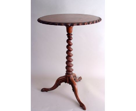 A late Regency rosewood tripod table, in the manner of Gillows, the circular gadrooned top on a barley twist column and scrol