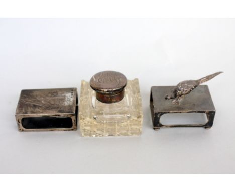 An Art Deco silver and glass inkwell, London 1926, with two silver matchbox covers, one with a pheasant to top