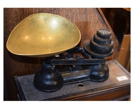 Set of black painted cast iron grocers scales with a brass egg shaped pan   Condition: 