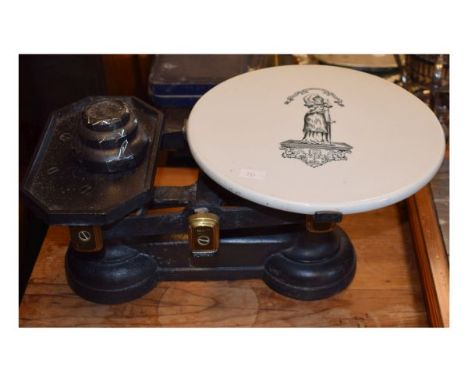 Set of grocer's cast iron scales having a black transfer printed ceramic platform decorated with the figure of Justice   Cond