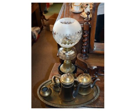 Brass paraffin lamp having a frosted spherical shade and faceted clear reservoir on bell shaped base and black circular plint