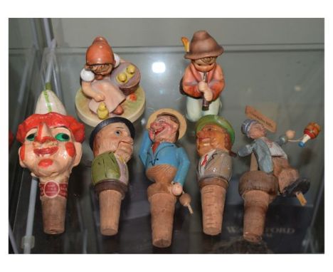 Two Goebel Hummel figures - Chick Girl and Little Tooter, together with five novelty carved bottle stoppers   Condition: 