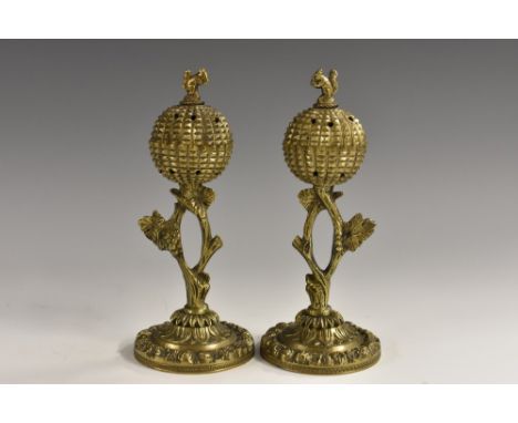 A pair of Regency gilt bronze pastille burners, each globular chamber crested by a squirrel and supported on a branch, circul