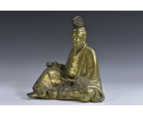 Chinese School, a polished bronze, of a seated sage, 27cm high