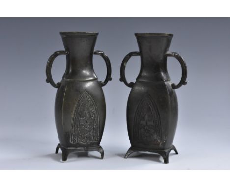 A pair of small Japanese patinated bronze flattened ovoid vases, cast in low relief with dart-shaped reserves of foliage rect
