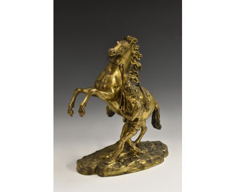 After Guillaume Coustou the Elder (French, 1677 - 1746), a gilt patinated bronze, Chevaux de Marly (Horse Tamers), signed in 