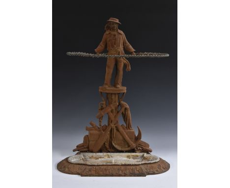 A 19th century cast iron walking stick stand, as a sailor, standing above a maritime trophy, rope twist support, the base wit