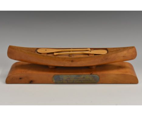 A mid-20th century hardwood desk model, of a canoe, the base with presentation plaque inscribed To Group Captain "Mo" Short, 
