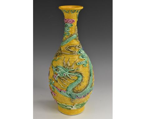 A Chinese ovoid vase, brightly decorated in polychrome modelled in relief with a ferocious dragon chasing a flaming pearl, on