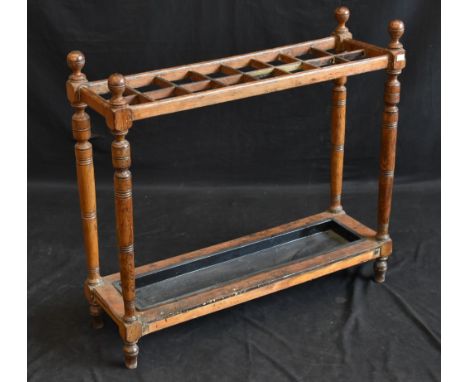 A late Victorian oak country house sixteen-division stick stand, spherical finials to angles, bar friezes, turned supports, r