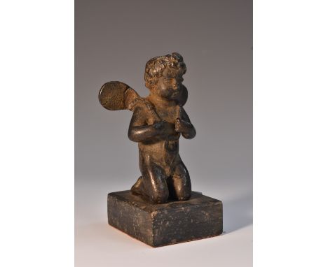 Continental School (19th century), a dark patinated cabinet bronze, in the Renaissance taste, as a kneeliong putto, rectangul