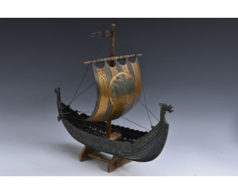 A Scandinavian bronze Viking ship, the main sail with a wrigglework eagle, oak mast, the hull with traces of verdigris, 42cm 