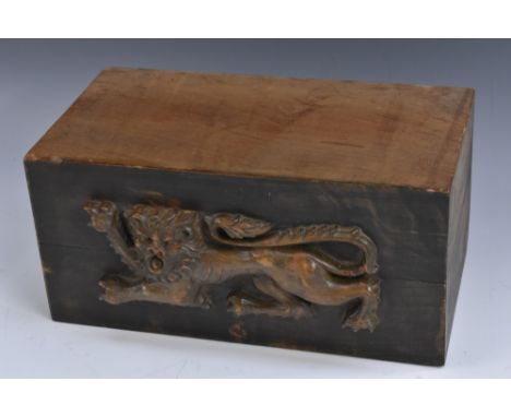 A heraldic architectural section, carved in relief with a lion passant, 28cm wide