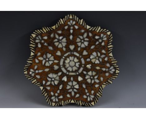 A late 19th century Ottoman hardwood and mother-of-pearl shaped circular table-top plateau, profusely inlaid with scrolling l