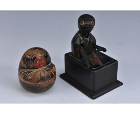 A Japanese Kobe toy automaton, as a comical figure eating from a bowl, rectangular base, 9.5cm high, Meiji period; another, a